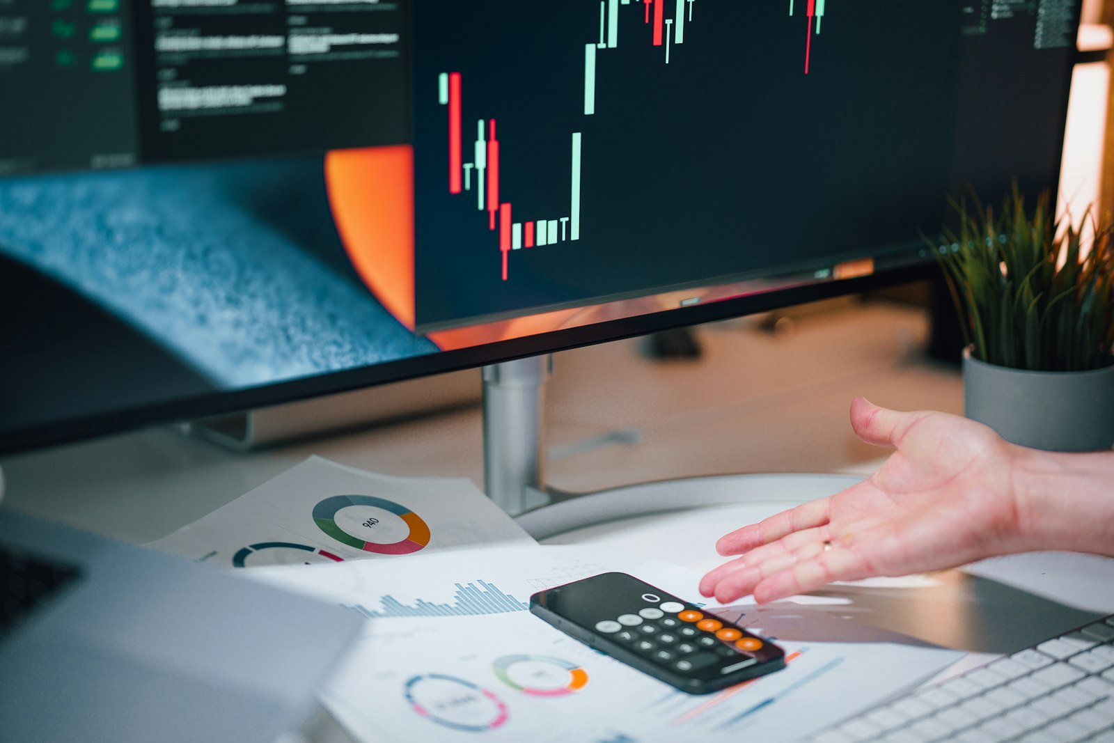Accountant pointing at a calculator on a desk