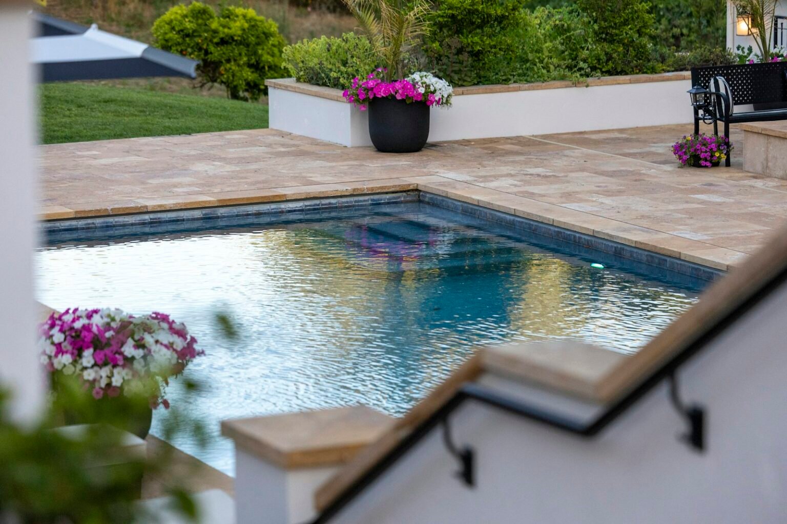 Backyard swimming pool with a patio