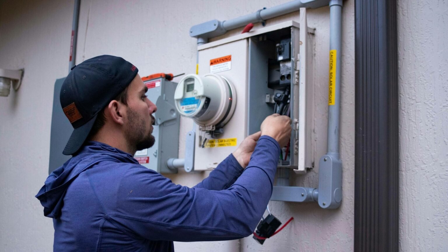Electrician working on a home electrical meter