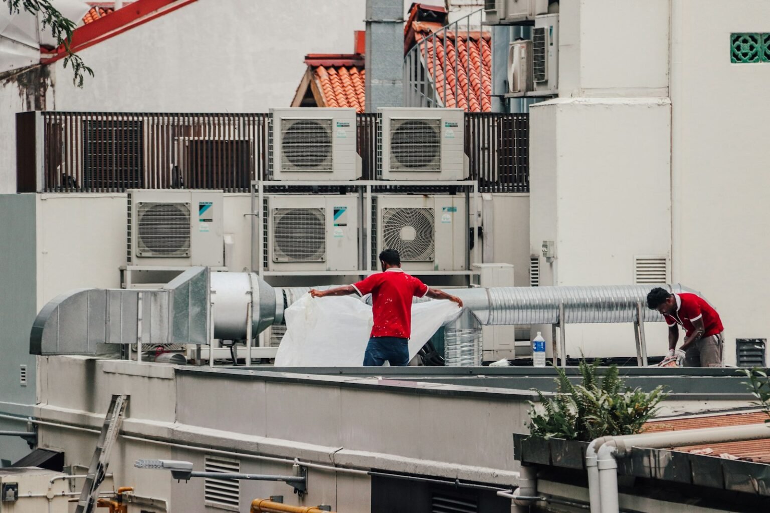 HVAC technicians working on rooftop units