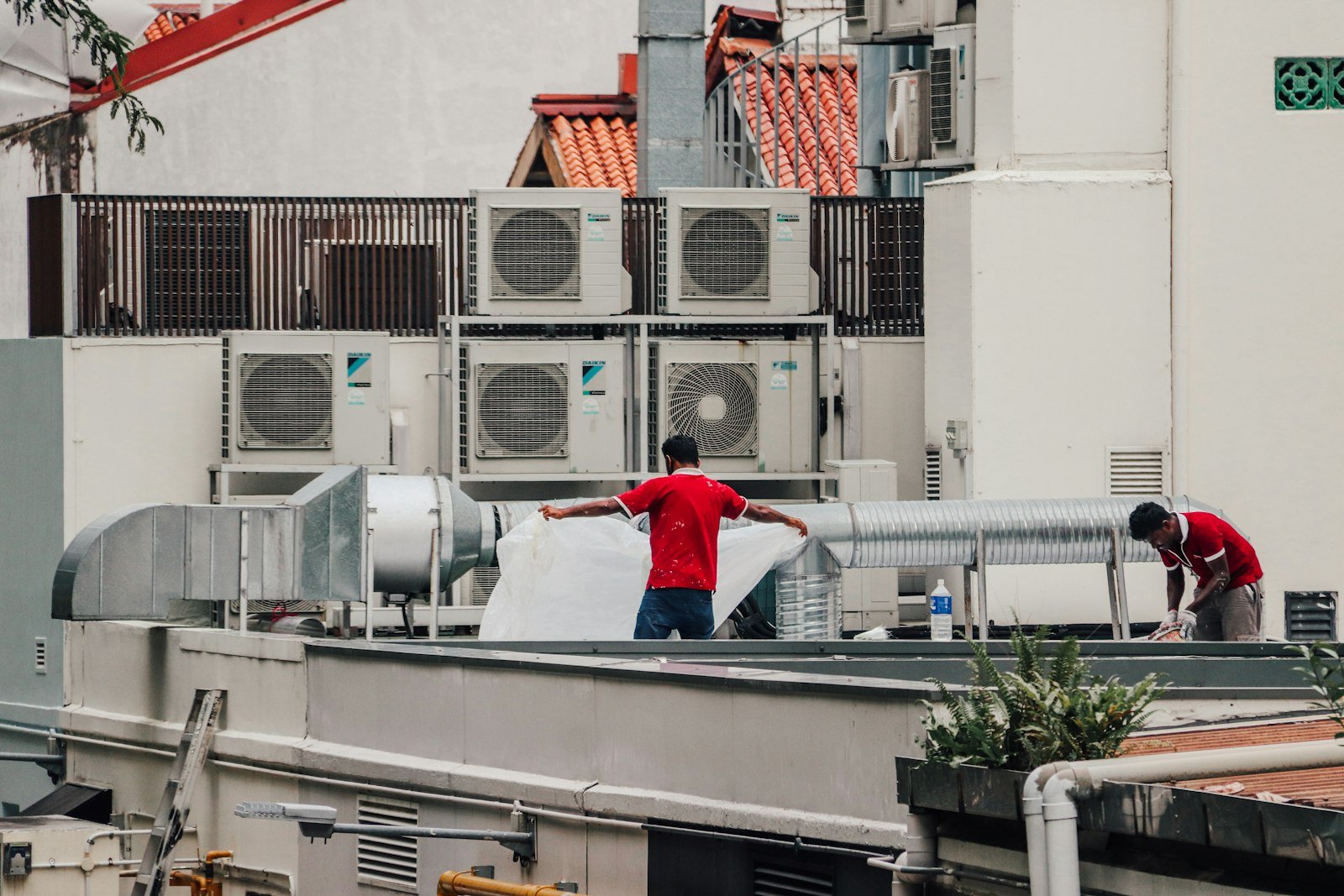 HVAC technicians working on rooftop units