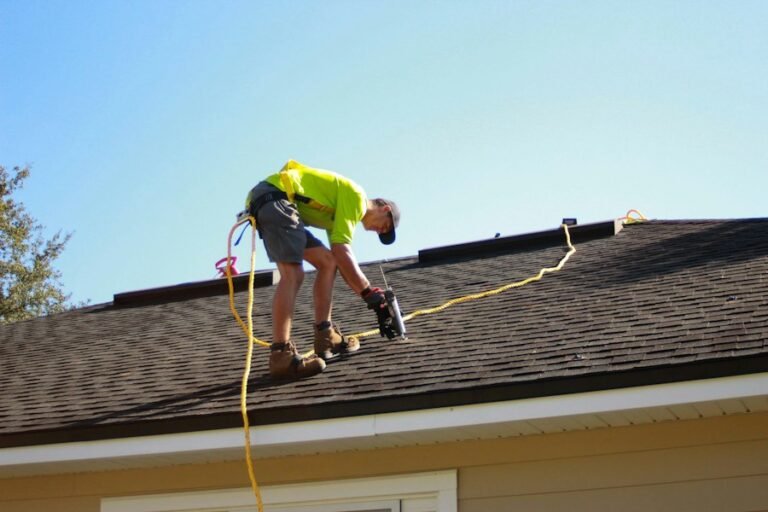 Roofer working on a house roof