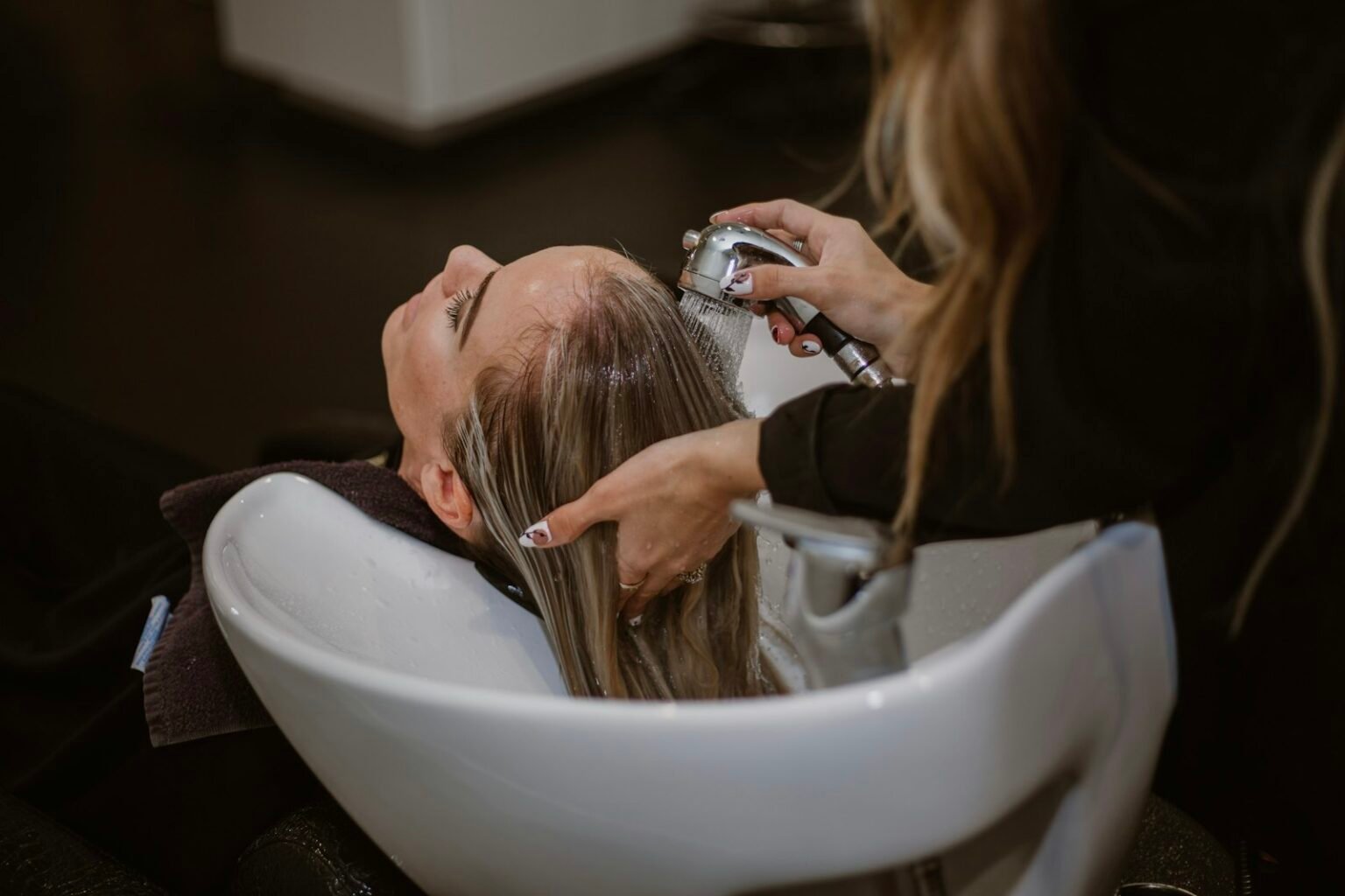Hair stylist working with a client